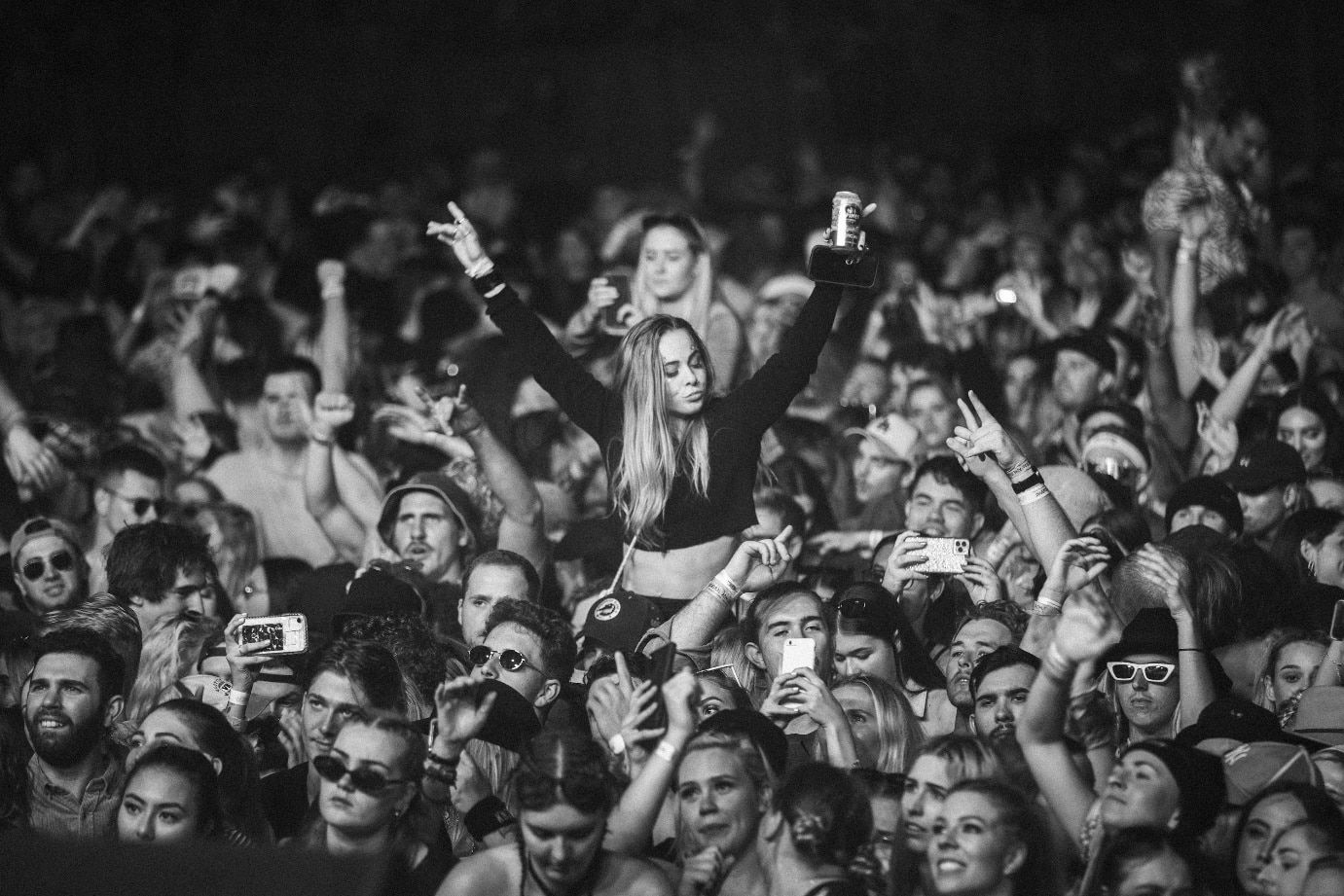 a woman standing in front of a crowd of people