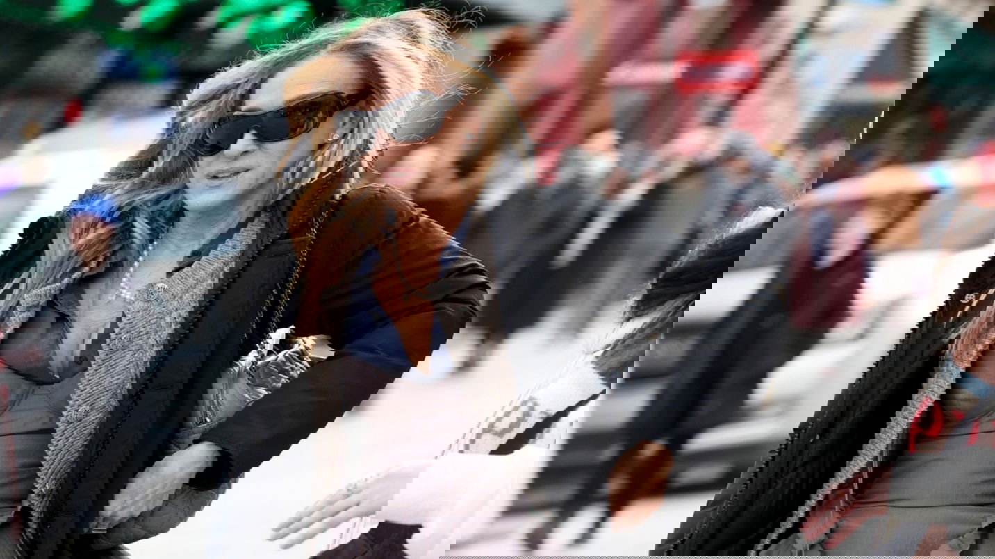 A person in a black coat

AI-generated content may be incorrect.