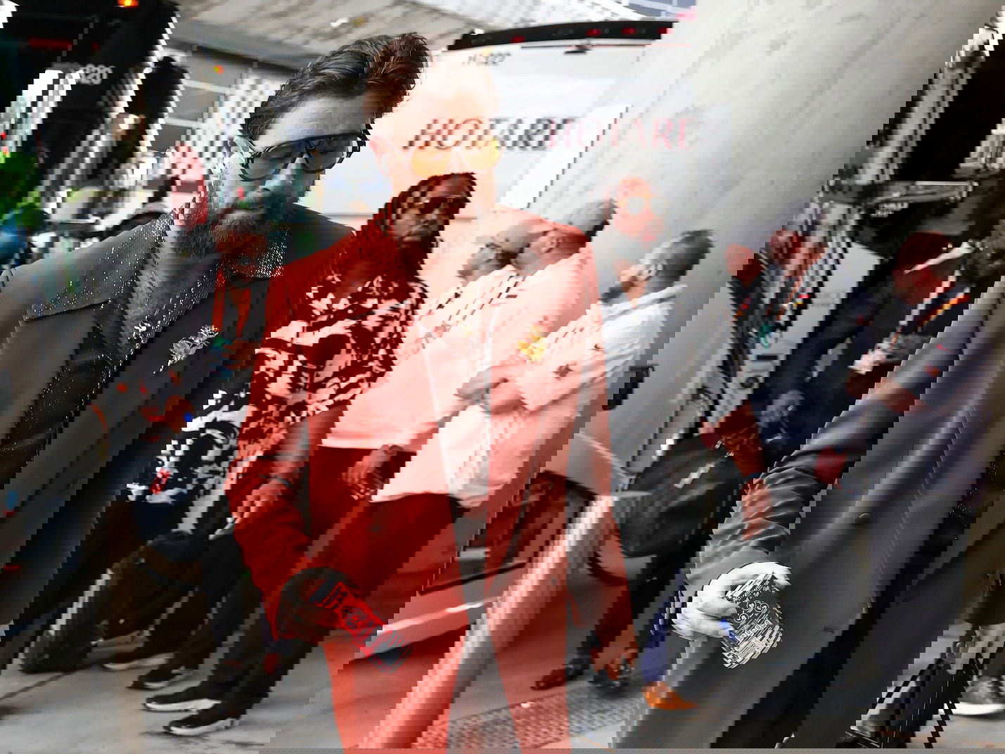 A person in a red suit and sunglasses

AI-generated content may be incorrect.