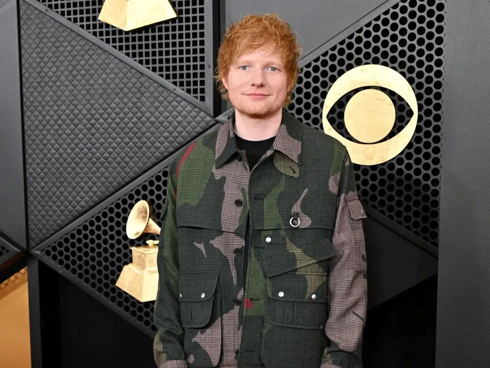 A person standing in front of a black and gold wall

AI-generated content may be incorrect.
